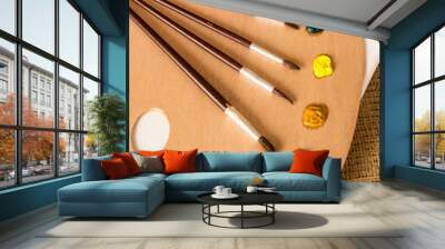 professional paintbrushes lying on wooden pallet with oil paints Wall mural