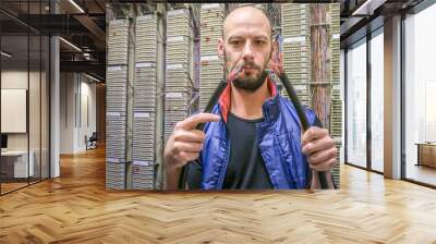 A technician holds in his hands the two ends of a torn telephone cable. An engineer will connect a damaged Internet backbone. The worker restores the connection in the data center server room. Wall mural