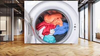 Dirty clothes are inside the washing machine. Automatic washer with open door. Erasing home t-shirts. Wall mural