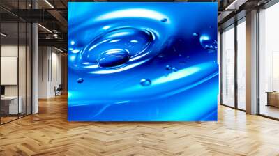 Close up of blue liquid with drop of water on it. Wall mural