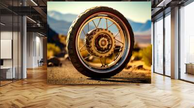 Close up of motorcycle tire on dirt road with mountains in the background. Wall mural