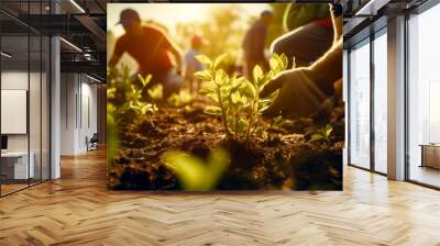 Group of people working in field with small plant in the foreground. Wall mural