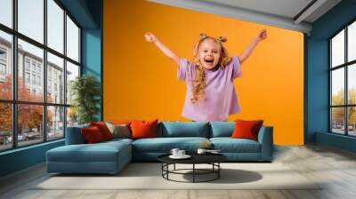 portrait of a happy child girl isolate on a yellow background, space for text Wall mural