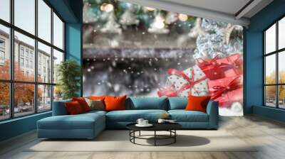 bag of Christmas gifts in the snow on the background of a festive Christmas tree with balloons and lights Wall mural