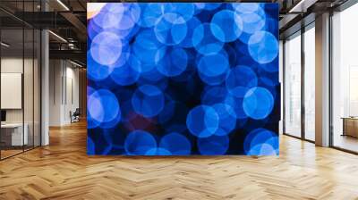 Abstract blue bokeh texture on black background Wall mural