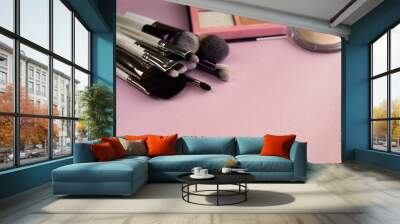 Makeup brush and cosmetics, on a pink background Wall mural