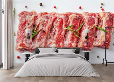 Isolated image of raw pork ribs with rosemary, pepper seasoning on a white background, top view.  Wall mural