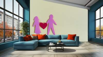 Cardboard figures of men and women and a red heart on a colored background. The concept of a happy relationship. Cardboard figures of people Wall mural