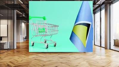 Empty metal shopping basket and Saint Lucia flag on colored background consumer basket concept Wall mural