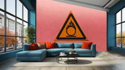 fire hazard warning sign in an orange triangle on a red background Wall mural