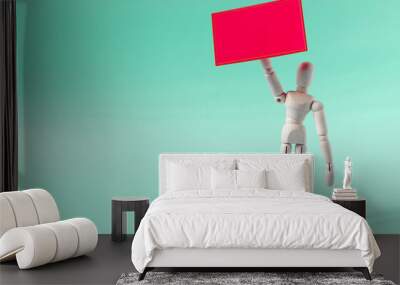 The figure of a wooden man holding a red poster in his hand. The figure of a wooden man with an empty sign. Wall mural