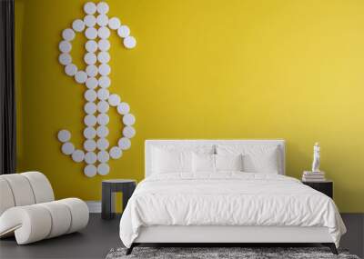 Pill. White pills on a yellow background in the form of a dollar sign from a white jar Wall mural