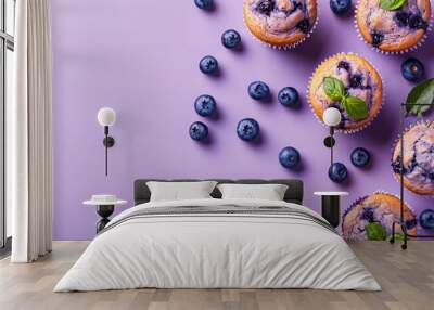 A close up of four blueberry muffins on a purple background. The muffins are arranged in a way that they look like they are sitting on top of a blueberry Wall mural