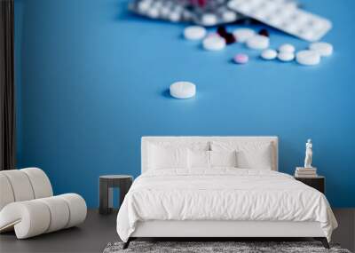 sorted pharmaceutical vitamins, tablets and pills used in medicine for treatment lie on a light blue Wall mural