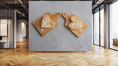 Two heart-shaped muffin blanks on small wooden planks against a gray concrete background. Wall mural