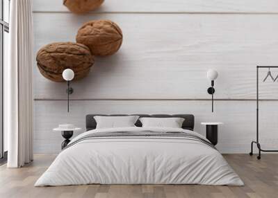 Walnuts on white wooden background. Wall mural