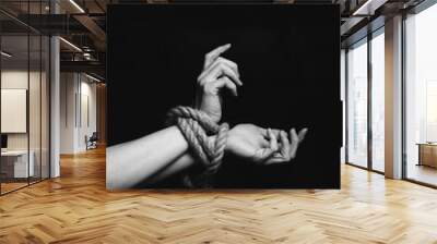 tied hands on black background Wall mural