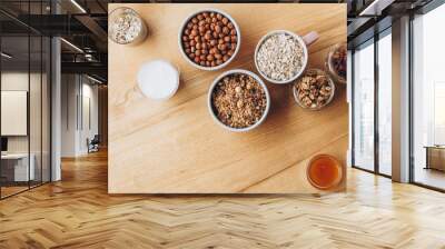 a delicious and crunchy oatmeal granola with honey, nuts, dried fruits and grains. Dynamic healthy food photography Wall mural