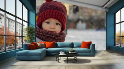 Child at winter. Happy little girl or boy outdoors in red hat Wall mural