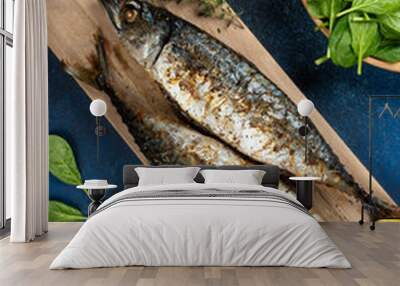 Baked mackerel fish on blue background, top view Wall mural