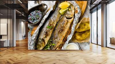 Fresh baked fish sea bass (Dicentrarchus labrax) on a light wooden background Wall mural