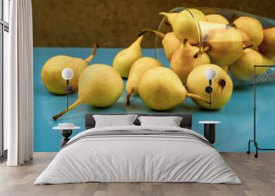 Yellow pears on blue background Wall mural