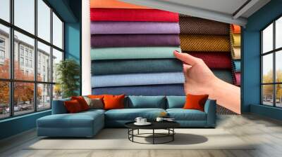 A young girl chooses fabrics from the catalog for her new sofa and chairs in her room, she chose fabrics with cool colors Wall mural