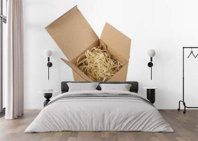 Cardboard open box with wood shavings. Box made of corrugated cardboard for storage of fragile things on a white background, isolated Wall mural