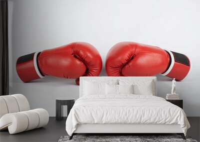 The concept of wrestling, competition - boxing gloves lie opposite each other on a light background Wall mural