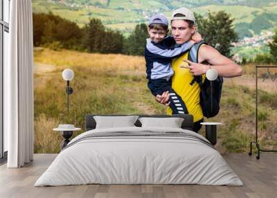 The little boy and his family climb the mountains and are tired of going on, and rest in the arms of a courageous older brother. A teenage boy helps his younger brother Wall mural