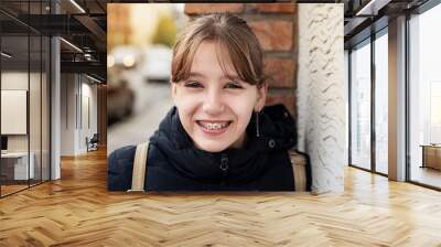 The young girl returns home from the dentist, she was fitted with braces to straighten her teeth, the girl is very happy and smiling. Dental concept Wall mural