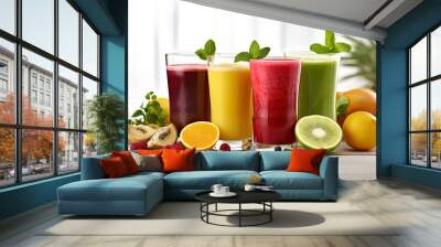 Close up image with four glasses full of fruit and berry juices surrounded by fruits and berries Wall mural