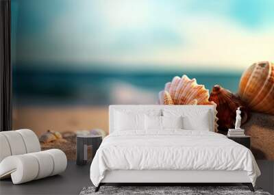 Starfish and seashells on the shore on clean sand on a blurred blue sea background Wall mural