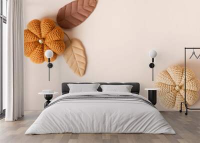 beige cozy background for text with knitted pumpkins and leaves Wall mural