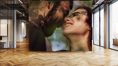 Head shot of young affectionate romantic couple in love. Close up portrait of attractive brunette girl and guy with eyes closed, close to each other. Concept of first kiss, tenderness and amorousness. Wall mural