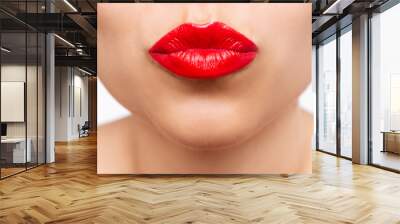 Cropped shot of a young beautiful caucasian woman blowing a kiss with her lips with glossy red color lipstick isolated on a white background. Beauty and fashion concept Wall mural