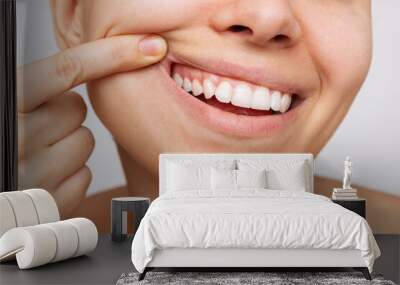 Gum health. Cropped shot of a young woman showing healthy gums. Dental care, dentistry concept Wall mural