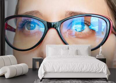 Portrait of a young caucasian woman with stylish female glasses for working at a computer with a blue filter lenses isolated on a white background. Anti blue light and rays. Eye protection Wall mural