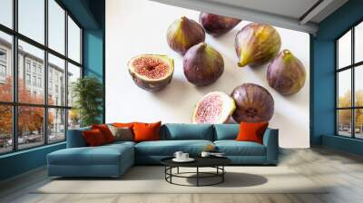 Ripe figs, purple green. Whole fruits and cut with red flesh and seeds. Grey-blue background. Wall mural