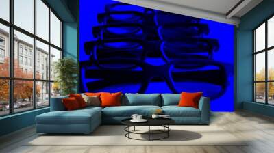 five black-rimmed glasses for watching 3D movies with the whole family on a blue background close-up Wall mural