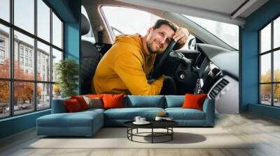 man sits in his lovely car. Wall mural