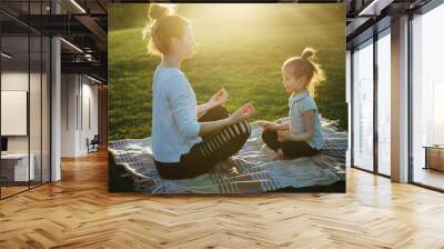 Mother practicing yoga with her daughter in the open air. Wall mural