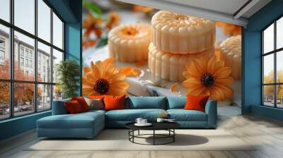 Delicate mooncakes placed alongside fresh orange flowers, combining sweetness with natural elegance, ideal for food styling or autumn-themed concepts. Wall mural