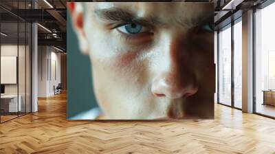 Close-up of a young Eastern European man with a serious expression, looking at the camera Wall mural