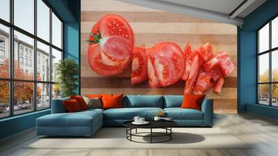 tomato sliced on the cutting desk. two halves of a tomato lie on a wooden board. Healthy red ripe tomato. Wall mural