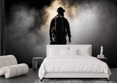 Silhouette of a military man standing on a dark background and smoke Wall mural