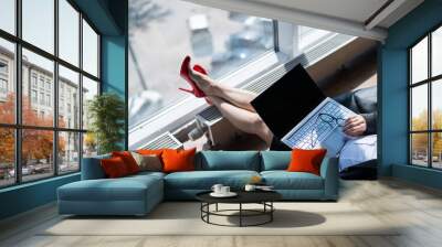 Caucasian woman fell asleep while sitting on bean bag and working on laptop in modern office Wall mural