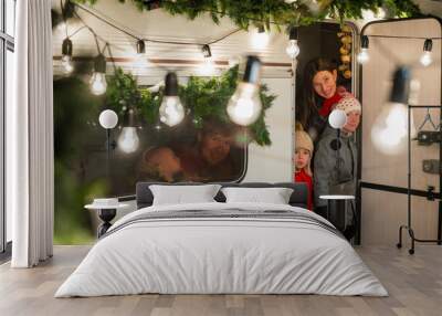 Happy large family celebrates christmas in nature. Parents with three sons travels in a mobile home.  Wall mural