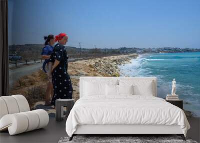 Two middle-aged women walking on the Mediterranean beach Wall mural