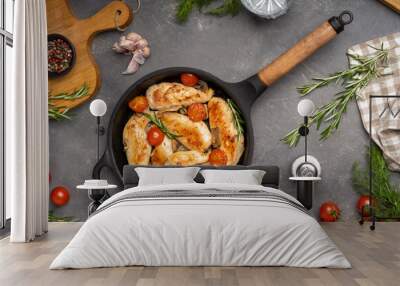 Grilled chicken breast or fillet with tomato on iron pan. Top view. Wall mural